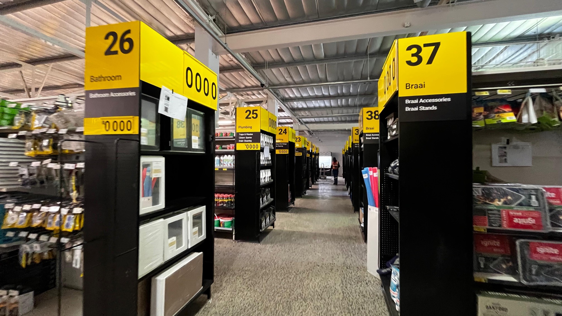 Yellow numbered aisle signs guiding shoppers through a retail store